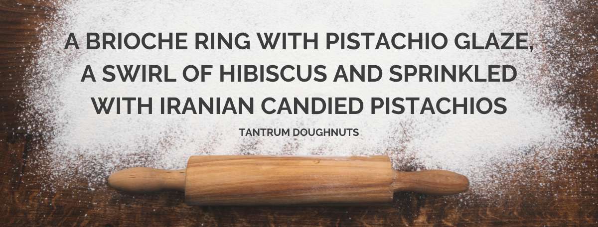 a brioche ring with a pistachio glaze, a swirl of hibiscus and sprinkled with iranian candied pistachio glaze - tantrum doughnuts